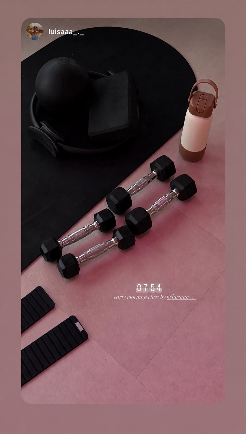 Blush nori bottle in a flat lay with dumbbells, a cap and a watch strap