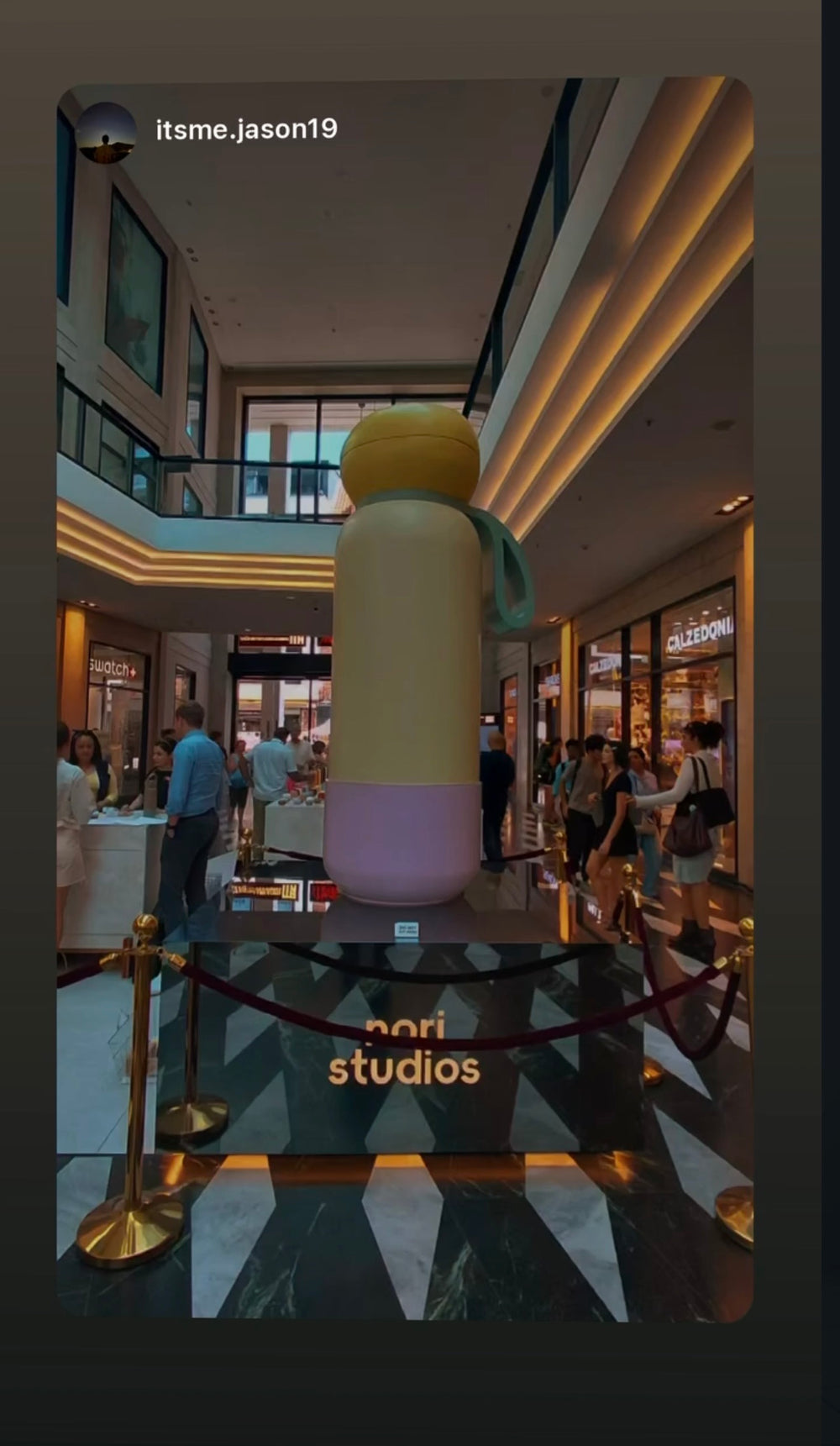 Oversized nori bottle display in a shopping centre atrium