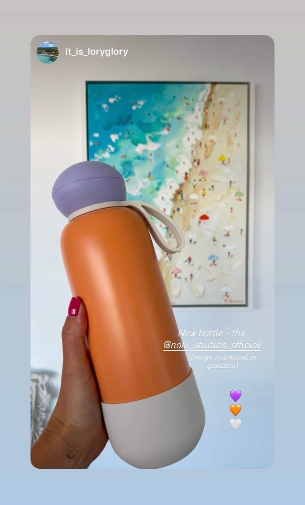 Orange and lilac nori bottle held in front of a beach painting
