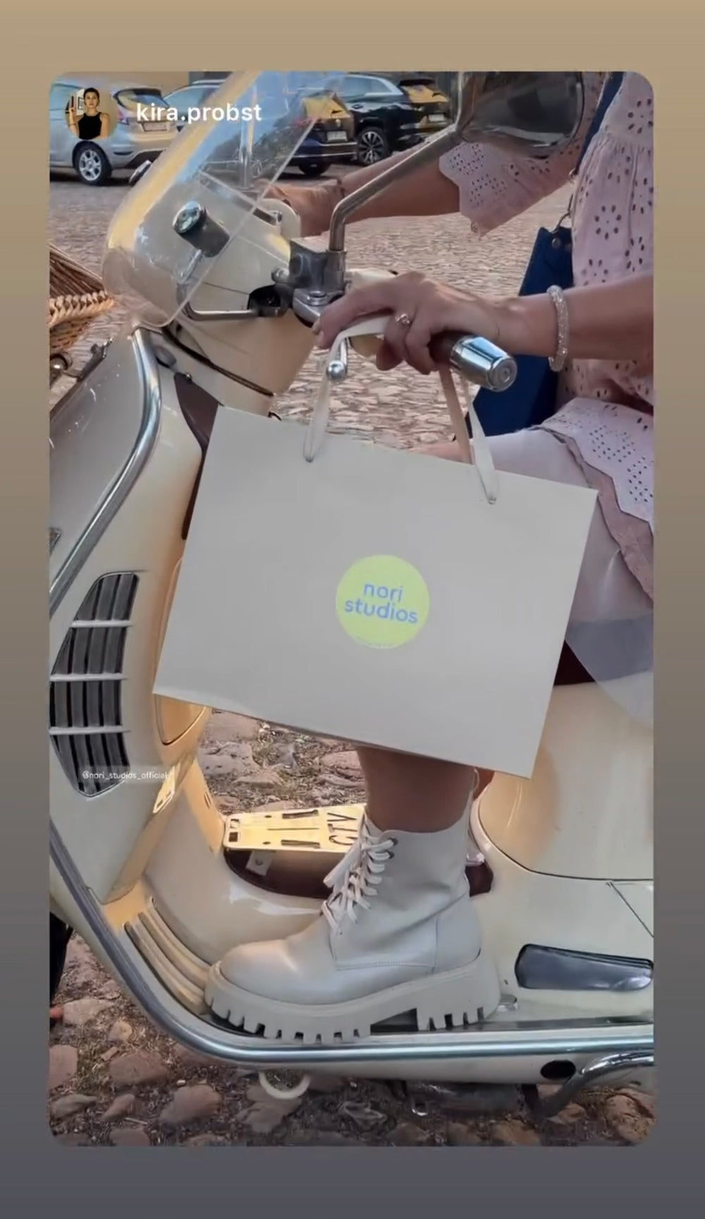 A nori studios shopping bag hanging from a scooter