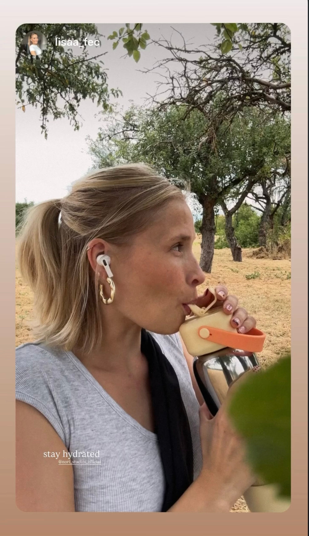 Drinking from a nori bottle out in an olive grove